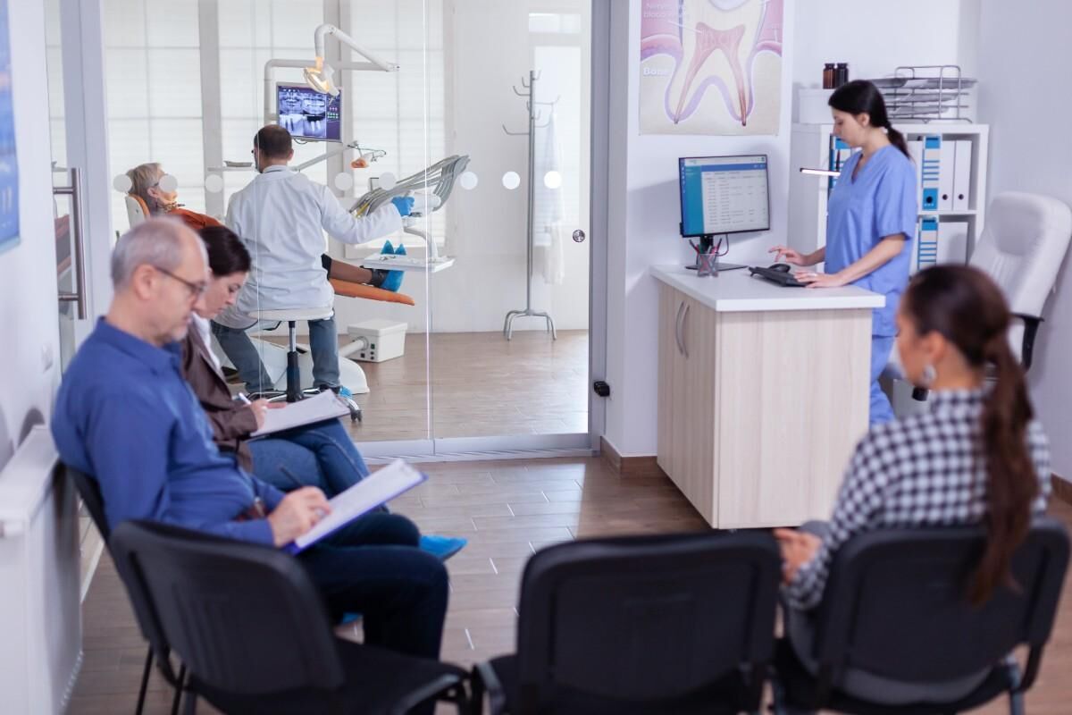 long-term-dental-care-benefits Patients waiting in dental clinic reception area