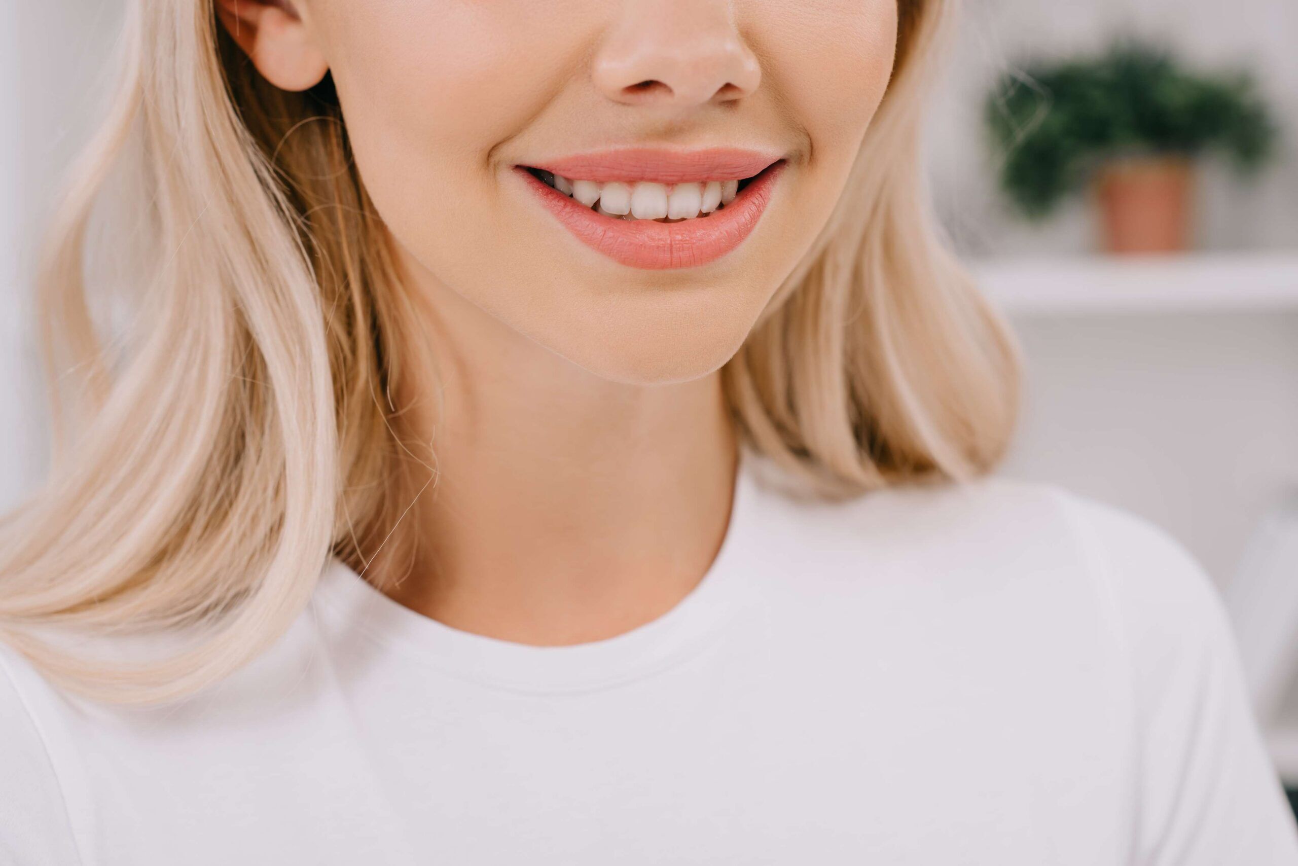 Close-up of a woman with a bright white smile.